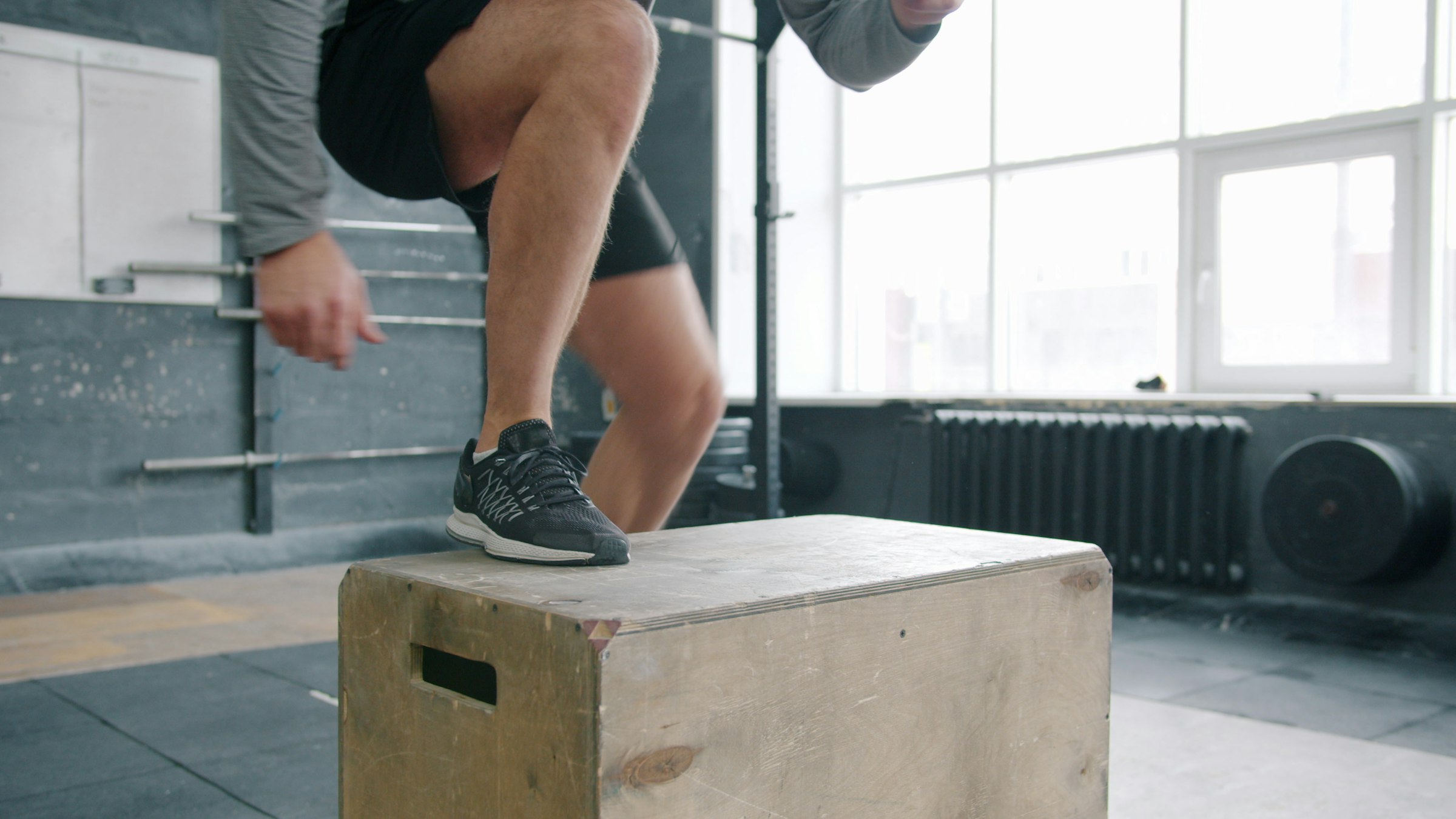Trainers landing on top of a wooden plyo box